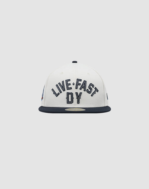 The LFDY X NEW ERA 59FIFTY by LIVE FAST DIE YOUNG is a white fitted cap with a dark brim, featuring bold LIVE FAST DY embroidery on the front. Größentabelle available for perfect sizing.