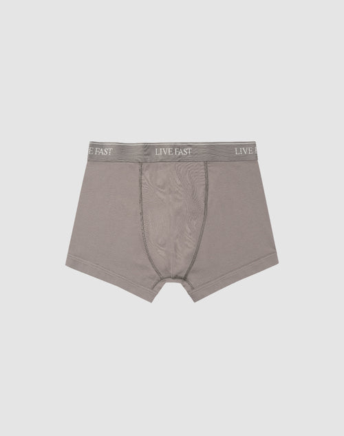 LIVE FAST DIE YOUNG’s Live Fast Trunks (2 Pack) feature soft gray cotton, a visible front pouch, and an elastic waistband with repeated LIVE FAST branding. Displayed flat on a light gray background. Care instructions included.