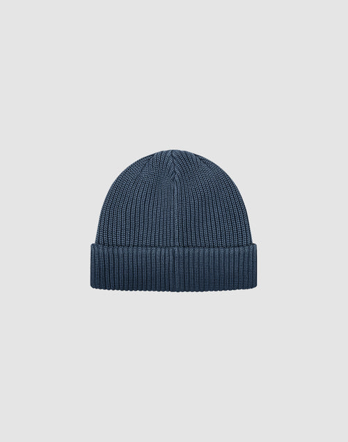 The LIVE FAST DIE YOUNG Double Rib Knit Beanie in dark blue features a folded brim and voluminous look, showcased against a plain light gray background.
