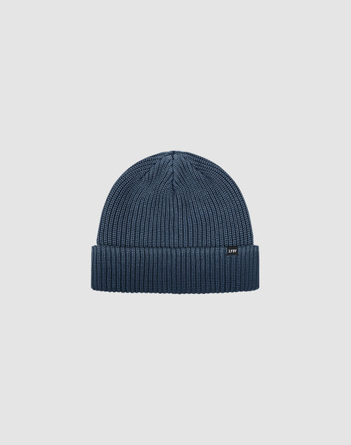 The LIVE FAST DIE YOUNG Double Rib Knit Beanie is blue with doppellagig gestricktem Design for a voluminöser Look, featuring a folded brim and small black front tag, shown on a plain light gray background.