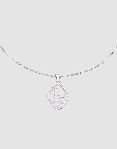 The LF Chain by LIVE FAST DIE YOUNG is a sterling silver necklace with a geometric pendant adorned with sparkling stones and stylized LF initials, featuring a zirconia charm, shown on a light gray background.
