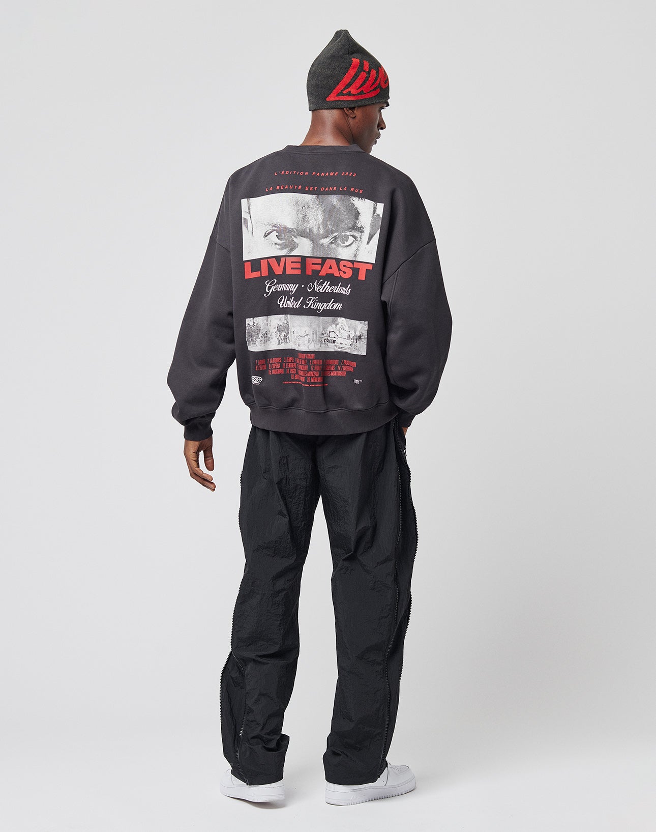 A man wearing the LFDY Cinema Sweater by LIVE FAST DIE YOUNG, made from soft cotton-polyester blend with an oversize fit.