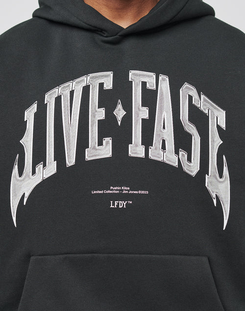 The Live Fast Axe Hooded by LIVE FAST DIE YOUNG is a black, oversized hoodie made from soft cotton, featuring bold white gothic LIVE FAST text, smaller details referencing Jim Jones and a limited collection.