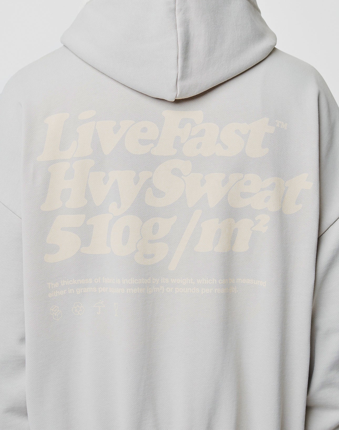 A person wearing the LIVE FAST DIE YOUNG Basic 510 Hooded Zip, featuring an oversized fit and stylish backprint topstitching.