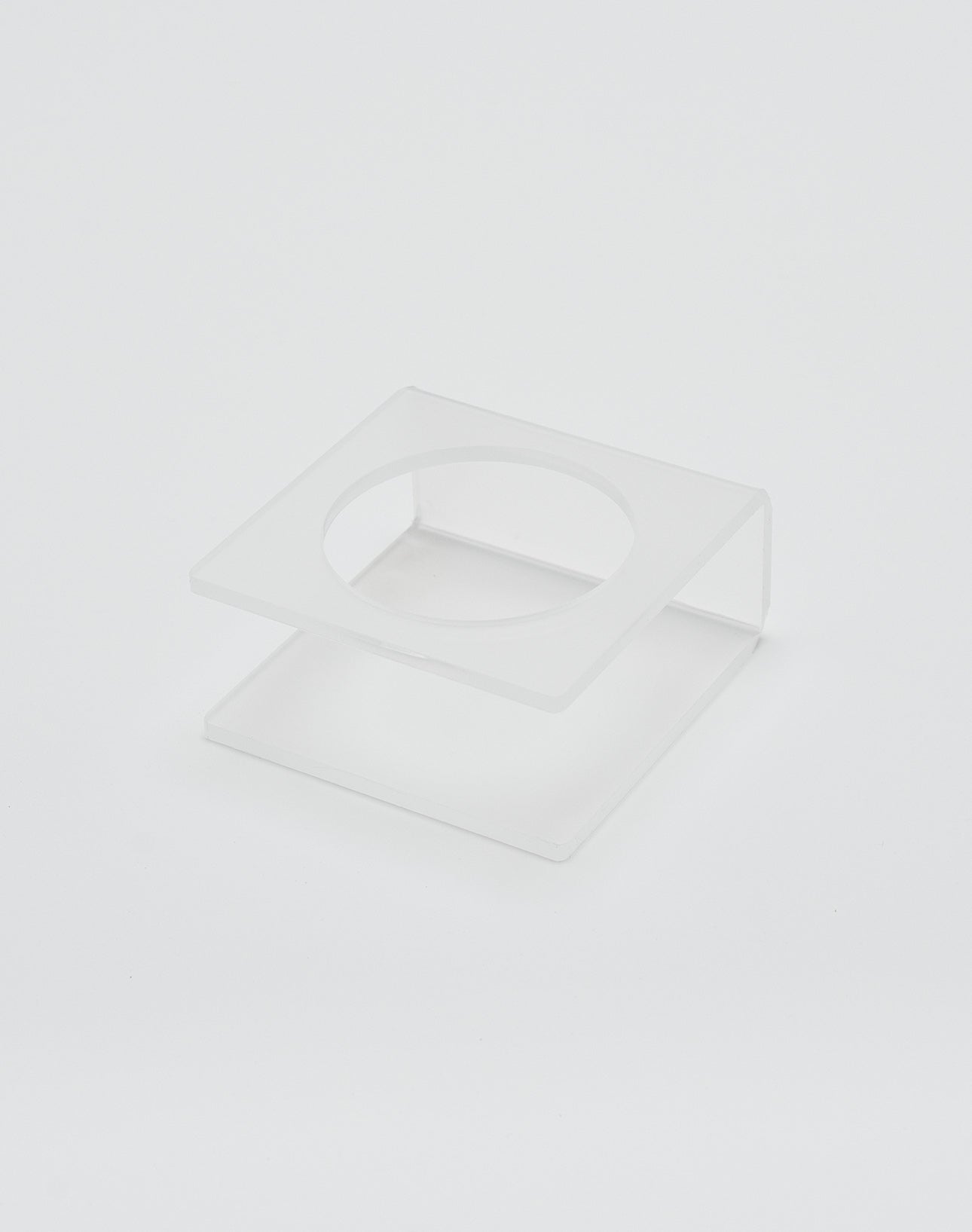 The LIVE FAST DIE YOUNG Live Fast Basketball is displayed on a clear, square acrylic stand with deep grooves and a circular cutout in the top panel, shown against a plain white background.