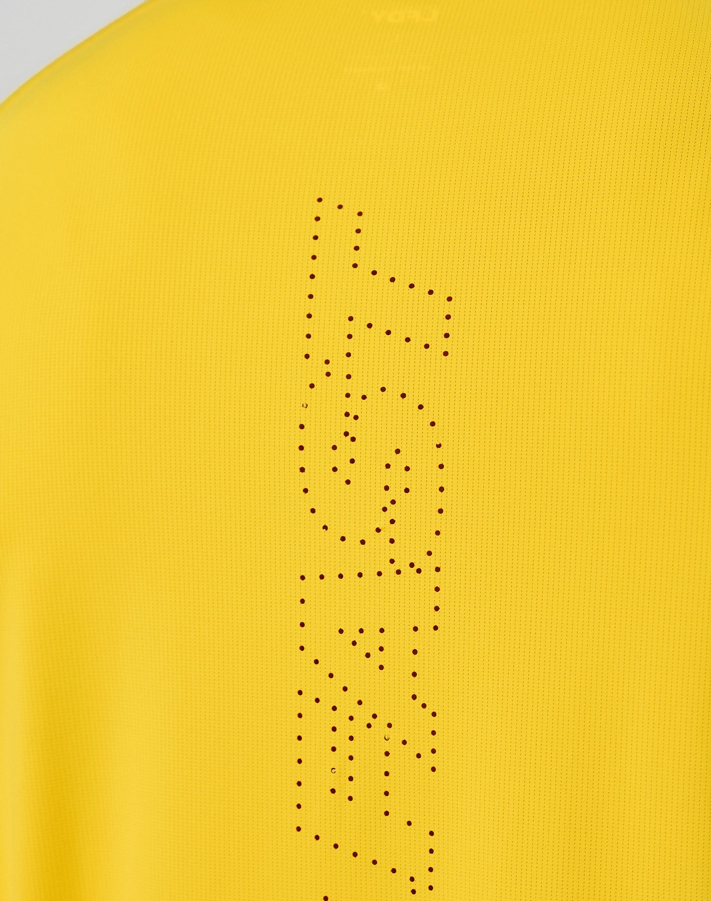 Close-up of the yellow Live Fast Performance Longsleeve by LIVE FAST DIE YOUNG, featuring a reflective front print with FAST vertically spelled out in small black dots.