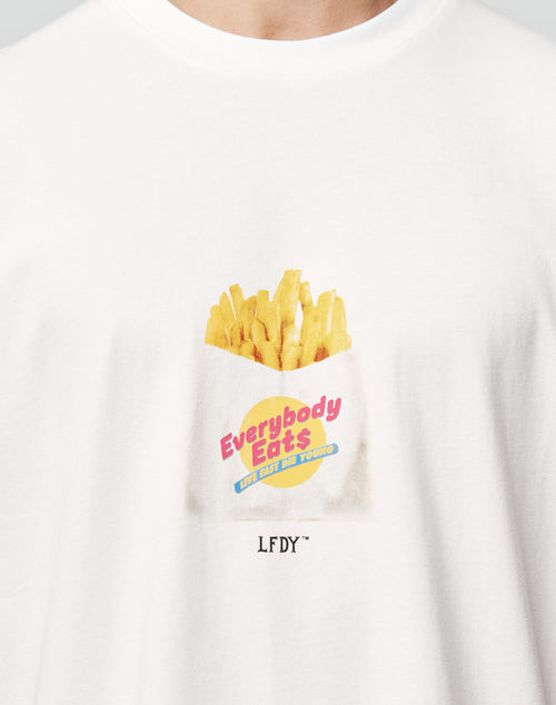 A close-up of the LFDY Fries Tee by LIVE FAST DIE YOUNG, a white Regular Fit cotton shirt featuring a French fries illustration with Everybody Eats Not Just For You, plus LFDY™ and LF2406-15695 printed below.