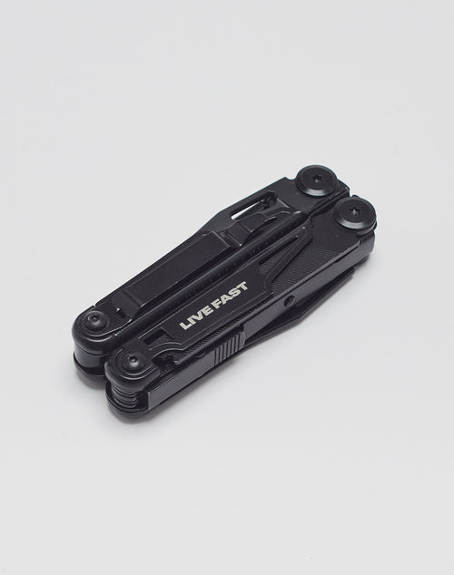 A black Live Fast Multifunction Tool by LIVE FAST DIE YOUNG, featuring “LIVE FAST” on its side, is shown folded against a plain white background.