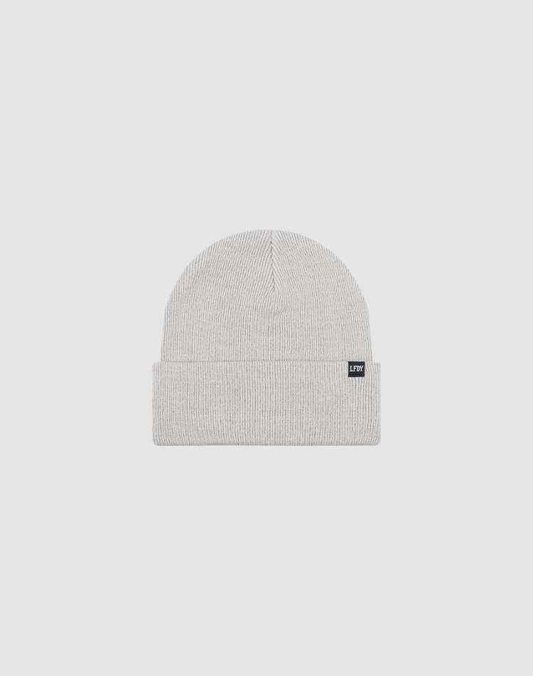 The LIVE FAST DIE YOUNG Basic Beanie is a light gray knit, one size, with a folded cuff and a small black rectangular flag-label, shown against a plain white background.