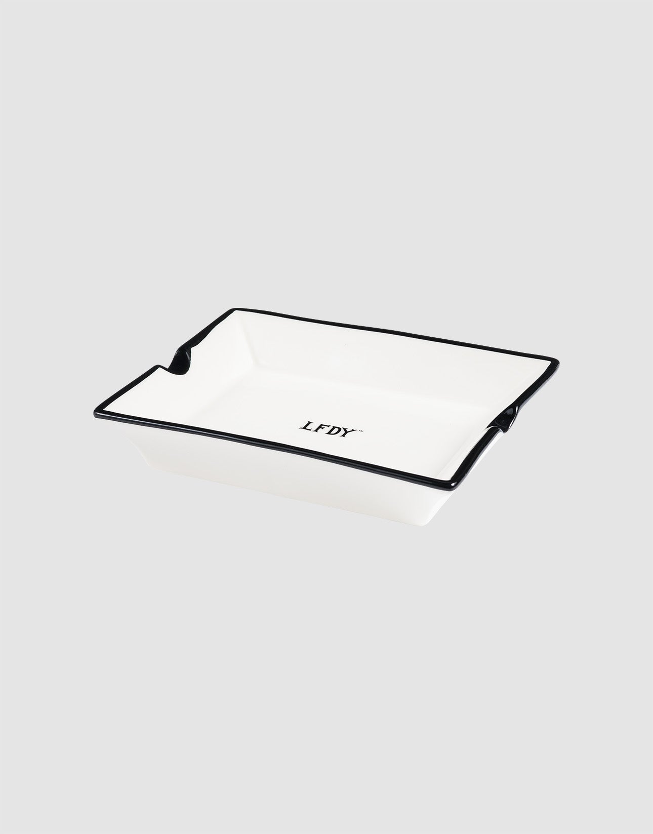 The LFDY Ashtray by LIVE FAST DIE YOUNG is a rectangular white porcelain ashtray with a black rim and central "LFDY" logo in black (Model LF2603-20136), shown on a light gray background.
