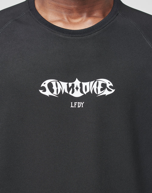 A person wears the black Live Fast Sports Longsleeve by LIVE FAST DIE YOUNG, made from 100% polyester with stylized white UNKNOWN and LFDY text on the chest. Only the shirt and part of their neck and chin are visible.