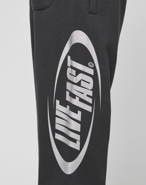 The LFDY Sphere Jogger by LIVE FAST DIE YOUNG features an oversize fit, elastic waistband, and a striking white oval LIVE FAST graphic on the leg. Made from soft cotton for all-day comfort.