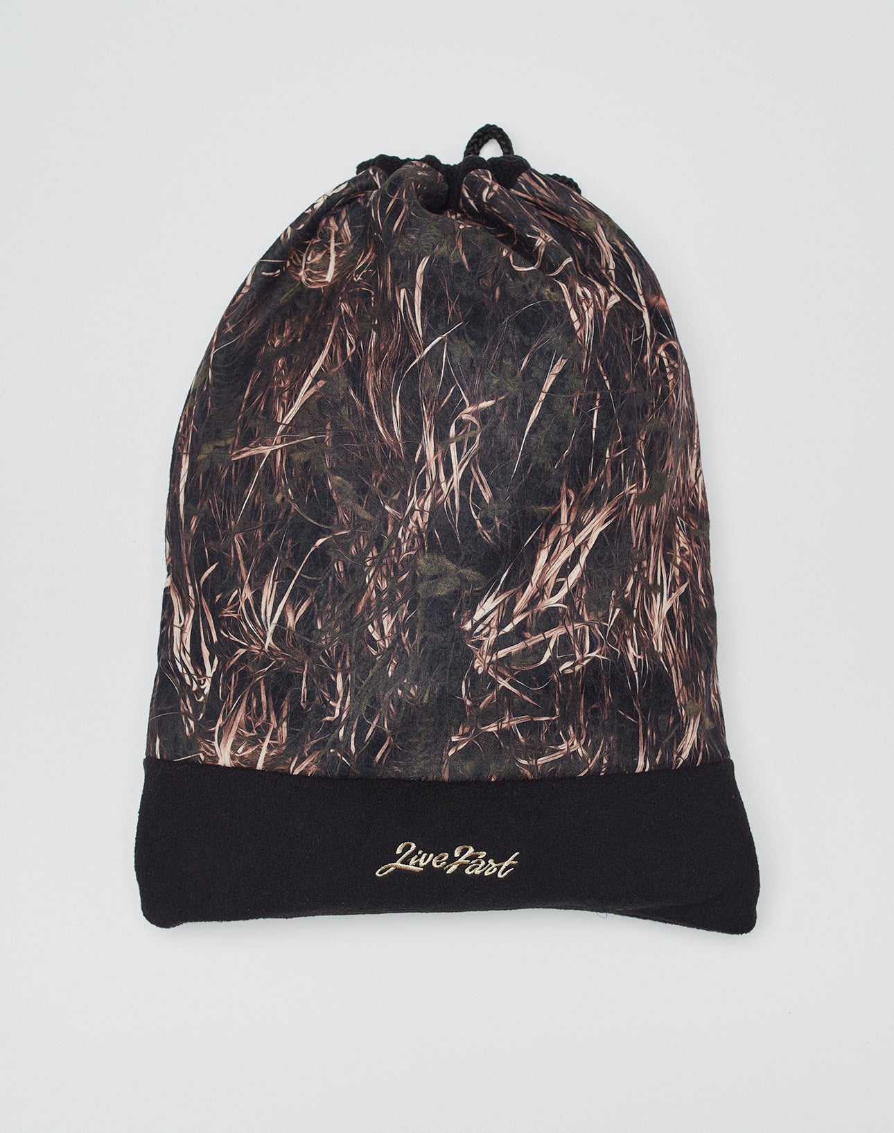 The Live Fast Gymbag by LIVE FAST DIE YOUNG features brown and black grass camo fleece with a black base, gold 2wo4our7 logo on the bottom, and is shown flat on a plain white background.