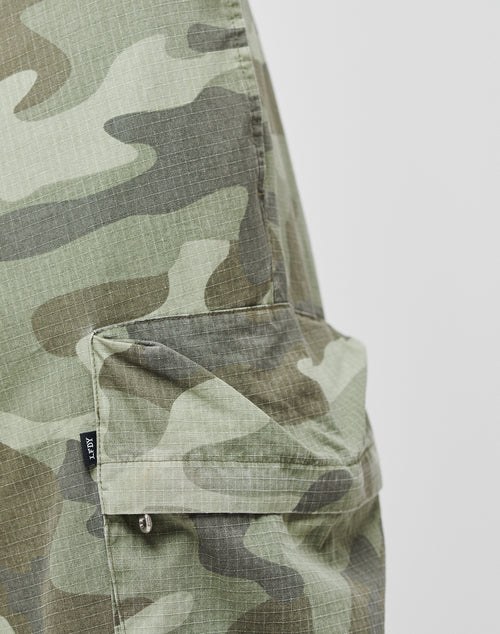 Close-up of Army Cargo pants by LIVE FAST DIE YOUNG, featuring a camouflage ripstop fabric in green, brown, and beige tones with a wide fit, side flap pocket, and practical cargo pockets for added utility.