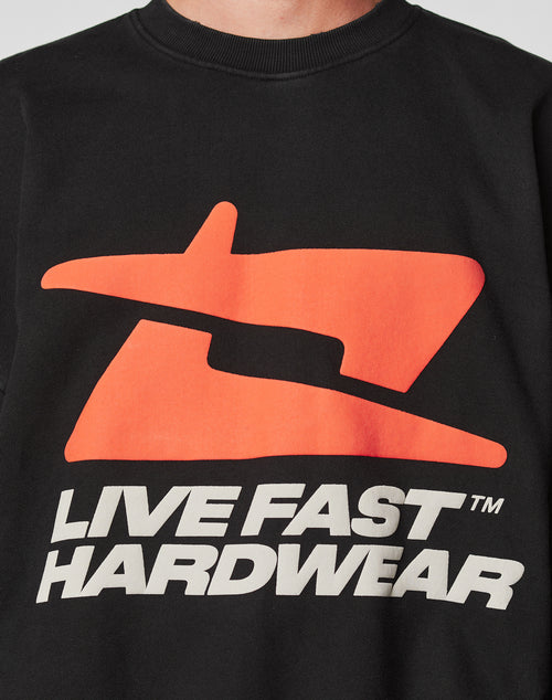 Close-up of the black LFDY Hardwear Sweater by LIVE FAST DIE YOUNG, featuring a bold orange abstract puffer print logo above “LIVE FAST HARDWEAR™” in large white letters. Designed in an Oversize Fit for ultimate comfort and style.