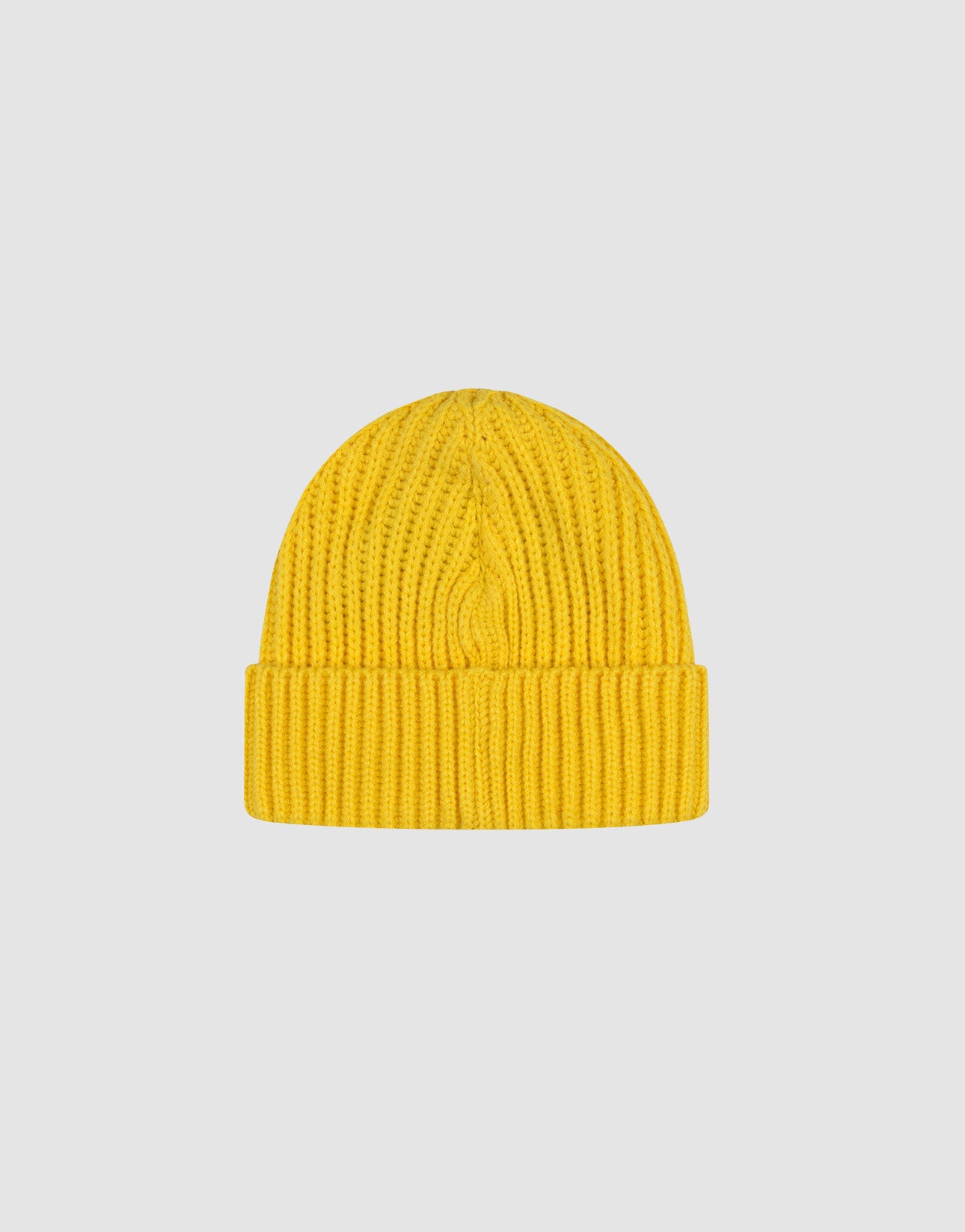 A yellow Rib Knit Beanie from LIVE FAST DIE YOUNG aus 100% Baumwolle mit gefaltetem Brim ist zentral auf einem schlichten, hellgrauen Hintergrund platziert.