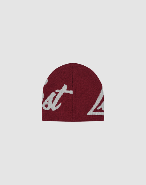 The LFDY Jacquard Beanie by LIVE FAST DIE YOUNG is a maroon polyamide knit hat with partially visible large white "Logo Strick" script lettering, displayed on a plain light gray background.