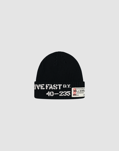 The Live Fast Army Beanie by LIVE FAST DIE YOUNG is a black ribbed beanie with white stitched text "LIVE FAST D.Y." and "40-2355" on the front, plus a web label featuring numbers and a red graphic. Made from 100% Baumwolle for comfort.