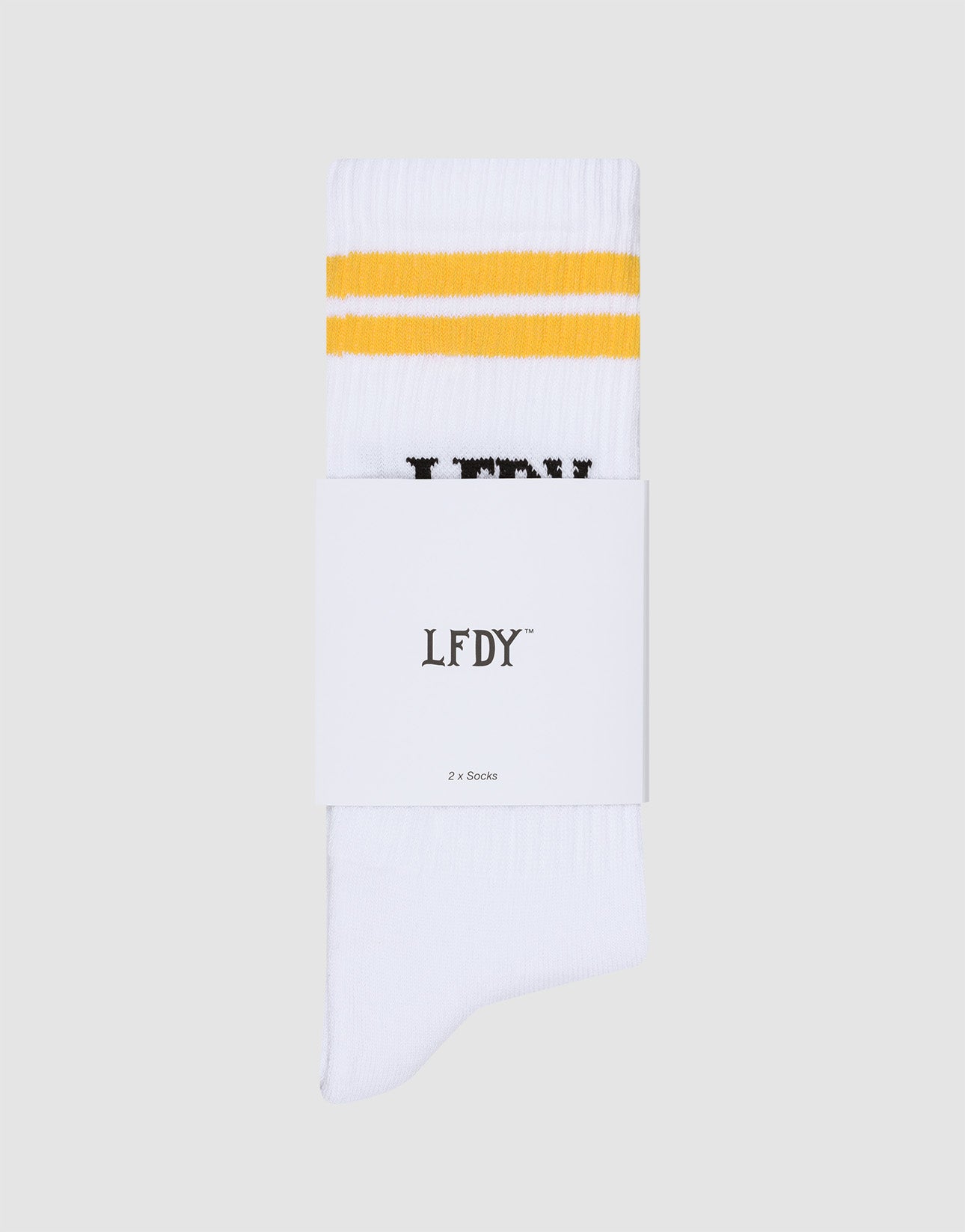A pair of white LIVE FAST DIE YOUNG LFDY Logo Socks (2 Pack) with two yellow stripes, folded with a label reading "LFDY 2 x Socks," shown on a light gray background. One size and easy-care (pflegeleicht waschen).
