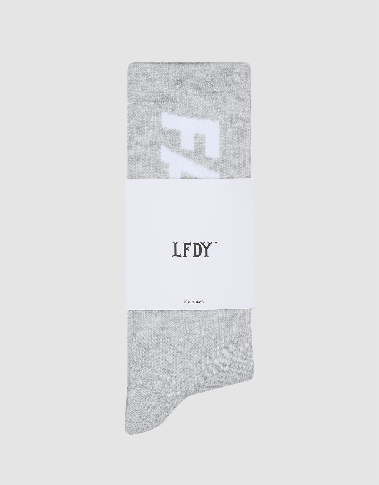 A pair of light gray Basic Typo Socks (2 Pack) by LIVE FAST DIE YOUNG with white lettering, folded neatly with a branded band reading LFDY and 2x Socks, One Size, against a plain light gray background. Perfect for easy-care laundry.