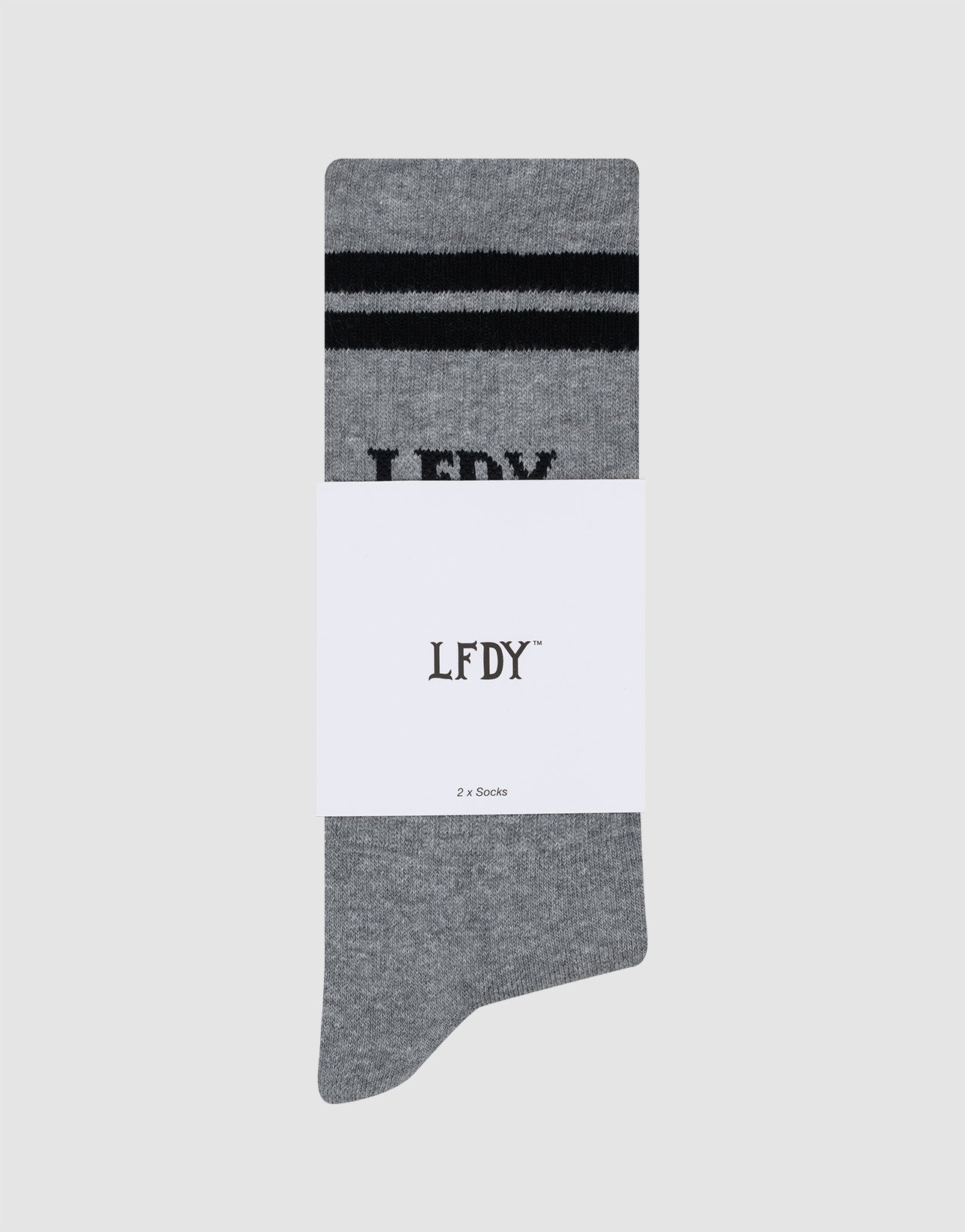 A single gray Basic Sock by LIVE FAST DIE YOUNG, made of soft Baumwolle with two black stripes and partial LFDY text, wrapped in a white band labeled LFDY⢠and 2 x Socks, shown on a plain light gray background.