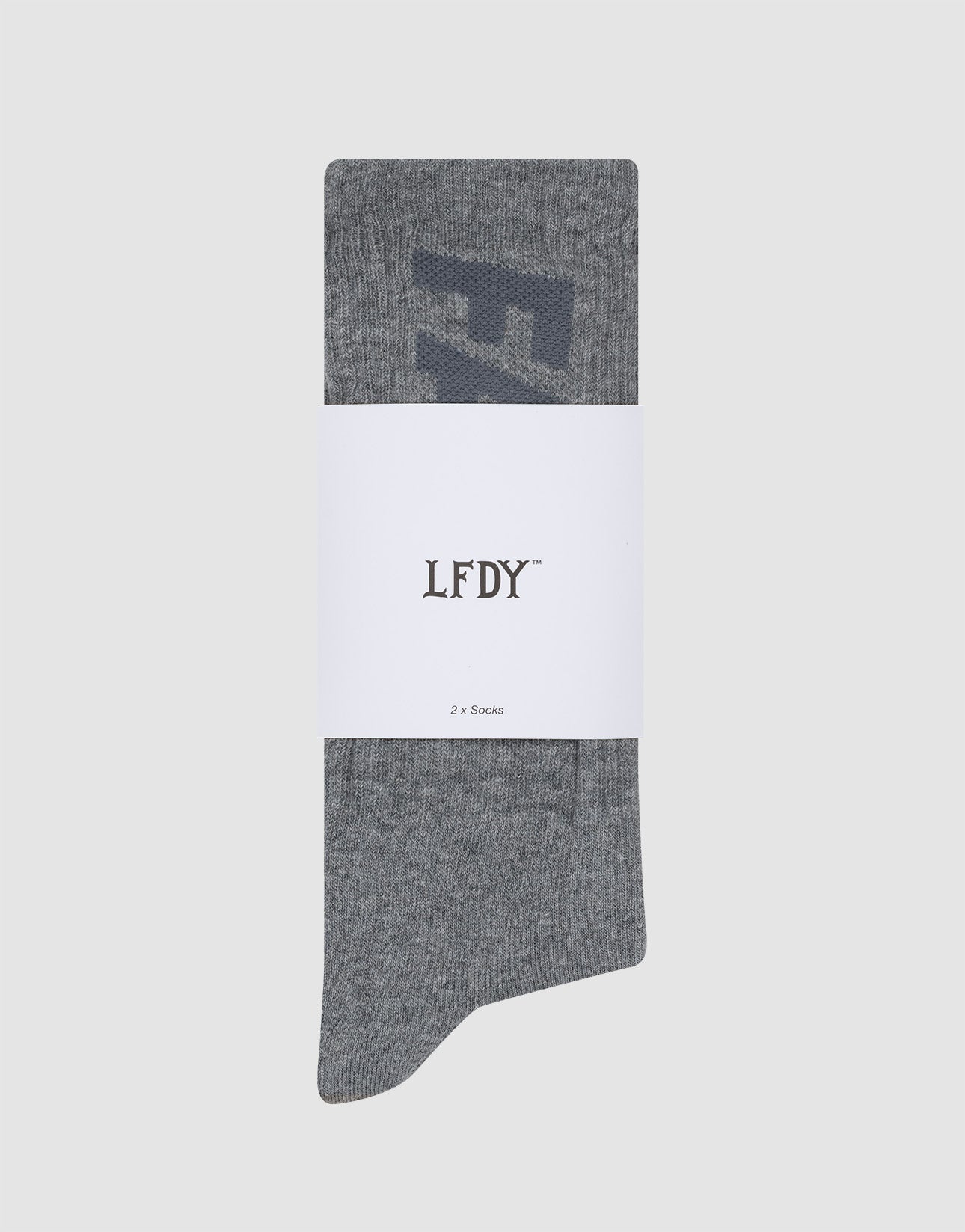 A single gray Basic Typo Sock (2 Pack) by LIVE FAST DIE YOUNG with a subtle design is wrapped in a white band labeled "LFDY" and "2er Set Socks," shown against a light gray background.