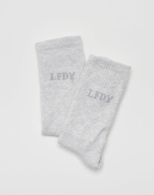The LIVE FAST DIE YOUNG LFDY Logo Socks (2 Pack) features light gray socks with a slightly darker gray LFDY logo on each, shown against a plain white background.