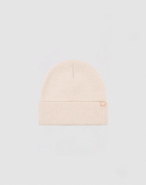 The LIVE FAST DIE YOUNG Basic Beanie is a plain, light beige polyacryl hat with a folded brim and a small flaglabel tag on the side, shown against a light gray background.