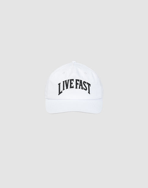 The Live Fast Unstructured Cap by LIVE FAST DIE YOUNG is a white cotton baseball cap with a bold black LIVE FAST logo and a practical snap closure, shown on a plain light gray background.