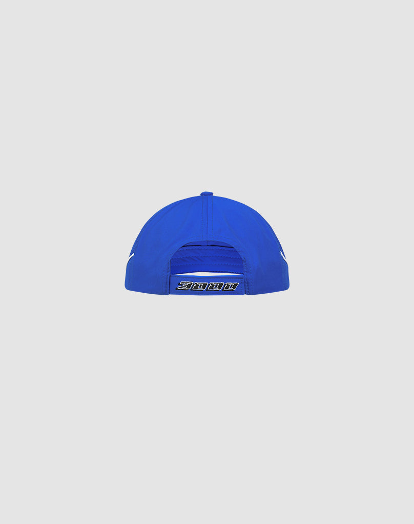 The Live Fast 3000 Cap by LIVE FAST DIE YOUNG is a blue polyester baseball cap shown from the back, with a Klettverschluss adjustable strap and a small Logo-Stick label above the closure, set against a plain light background.