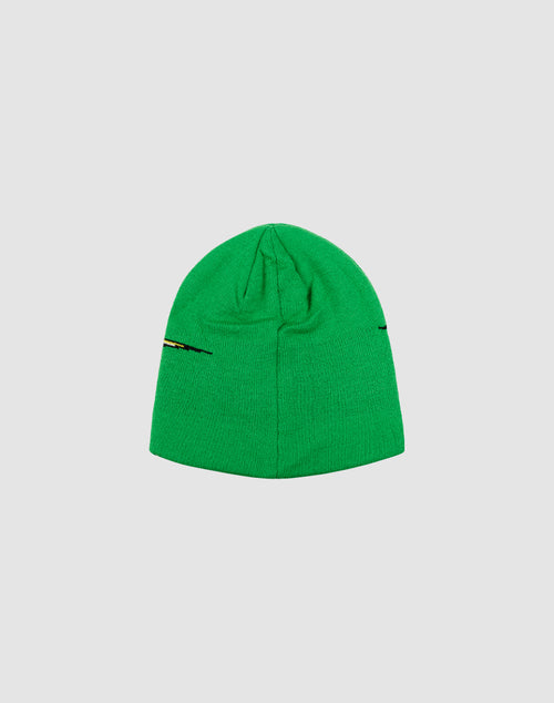 The LIVE FAST DIE YOUNG Live Fast 3000 Beanie is a green polyacryl knit hat with yellow, red, and black accents on one side, displayed on a light gray background. One size fits most.