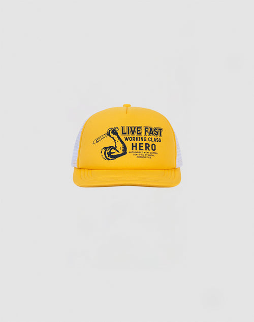 The LF Hero Cap by LIVE FAST DIE YOUNG is a yellow and white polyester Trucker Cap featuring LIVE FAST WORKING CLASS HERO and a flexed arm holding a wrench. Adjustable snap closure for the perfect fit.