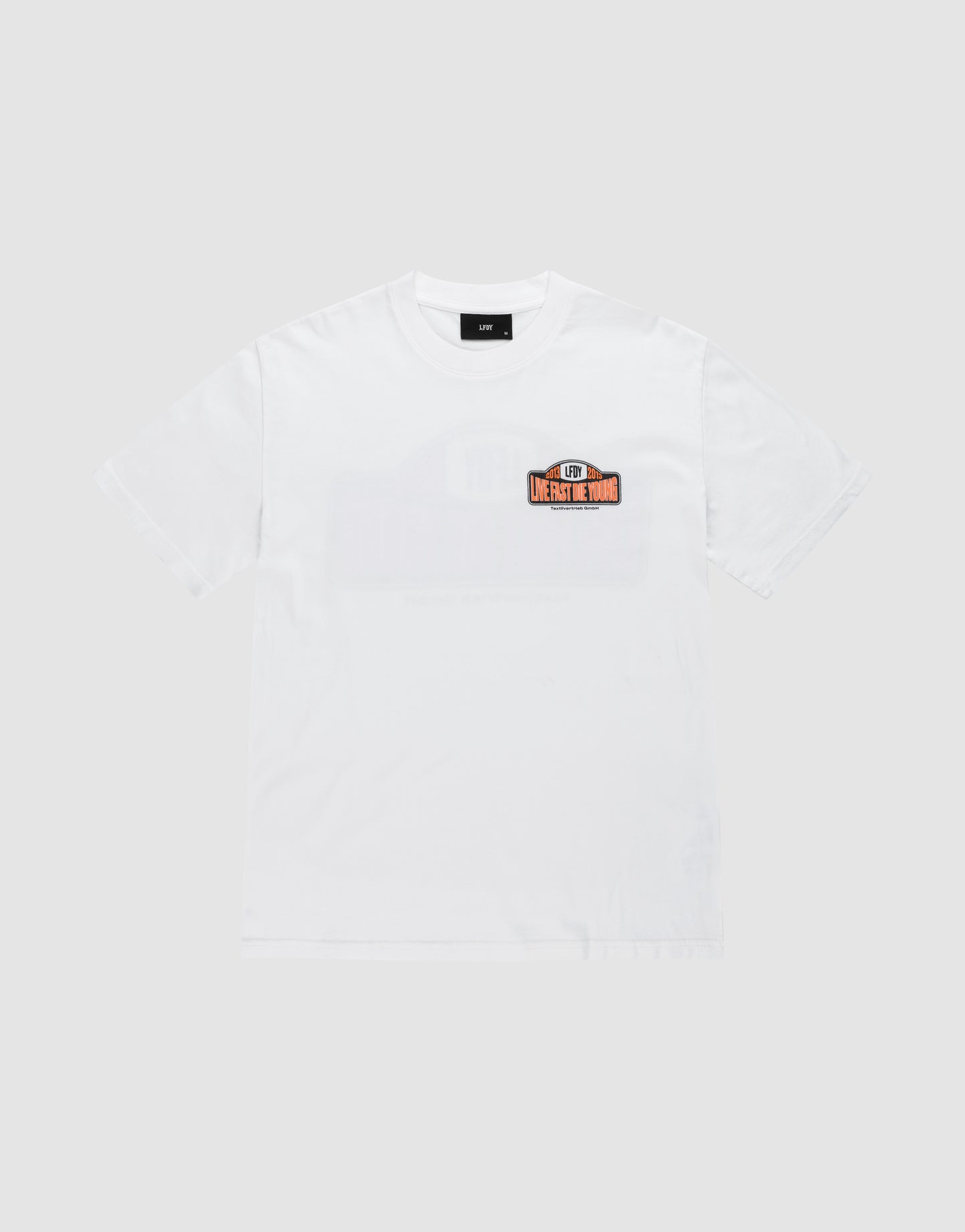 The Live Fast 2013 Tee by LIVE FAST DIE YOUNG is a plain white regular-fit short-sleeve t-shirt with topstitching and a small rectangular LH5 MERCH TOUR patch on the left chest. Made from 100% Baumwolle. Shown on a light gray background.