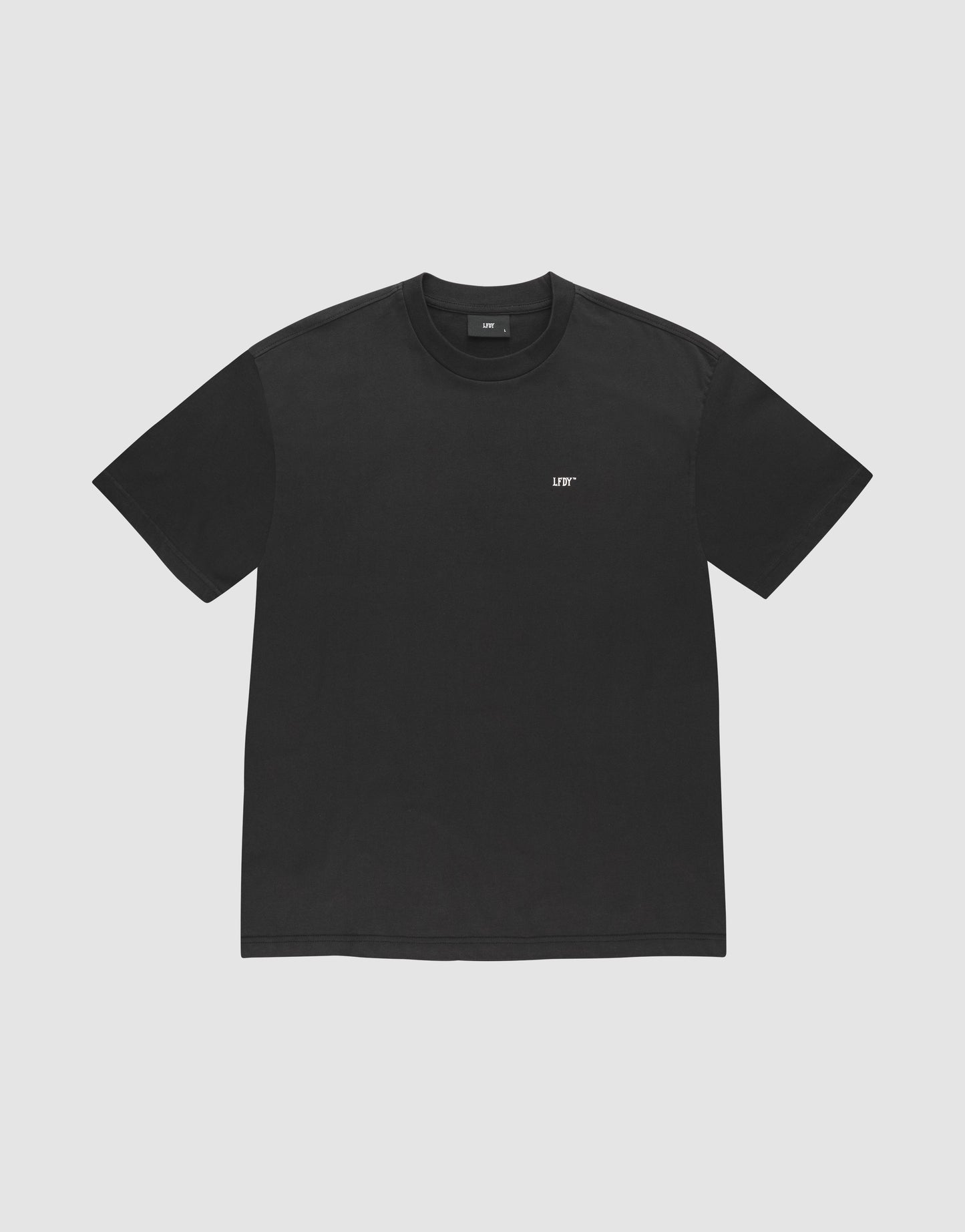The LFDY Monaco Boys Tee by LIVE FAST DIE YOUNG is an oversize fit, short-sleeve black t-shirt with a small white LIFT logo on the left chest, made from 100% Baumwolle, shown on a light gray background.