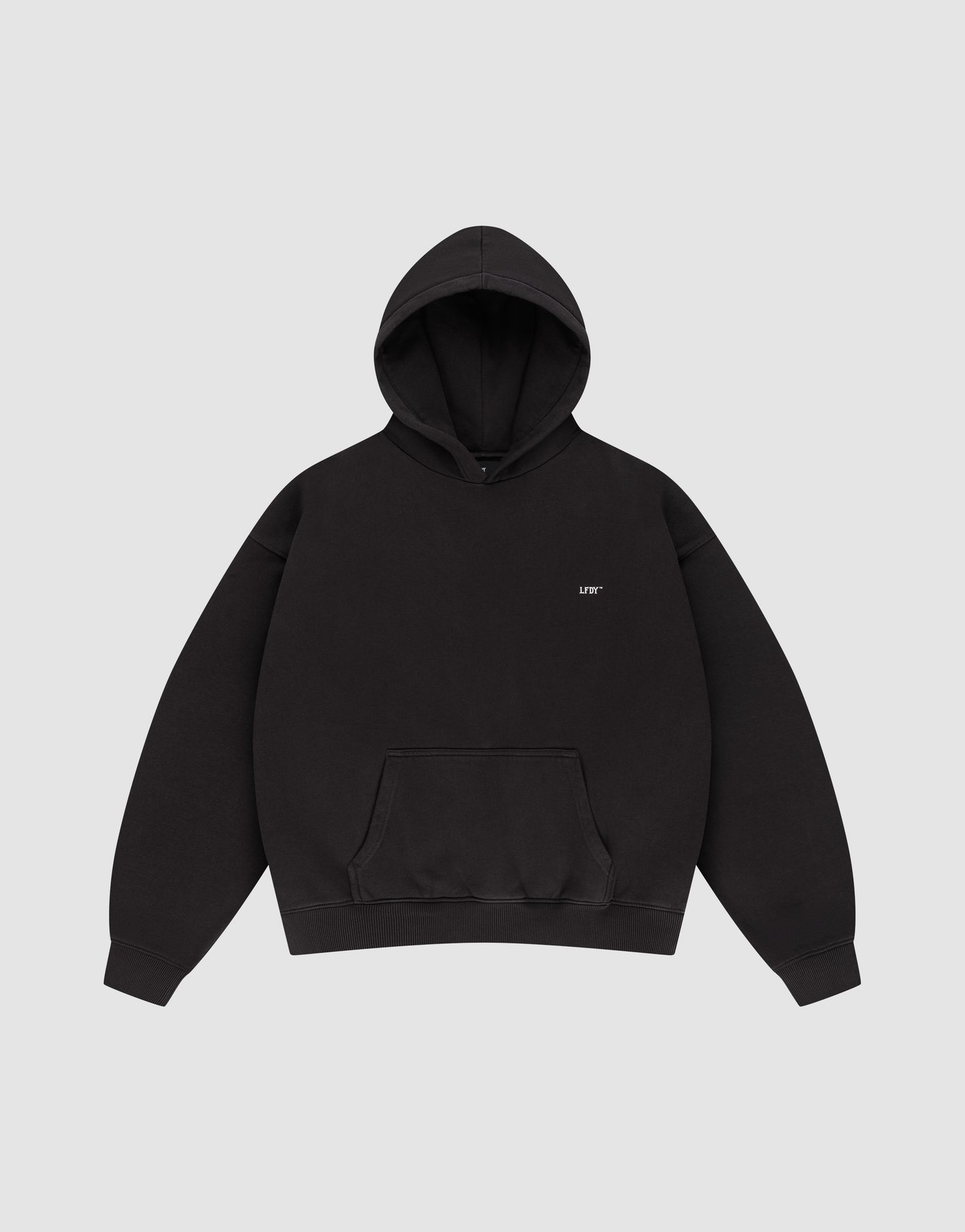 The LFDY Monaco Boys Hooded by LIVE FAST DIE YOUNG is a plain black, oversized hoodie with a front pocket and hood, featuring small white "LIFE" text on the left chest, shown on a light gray background.