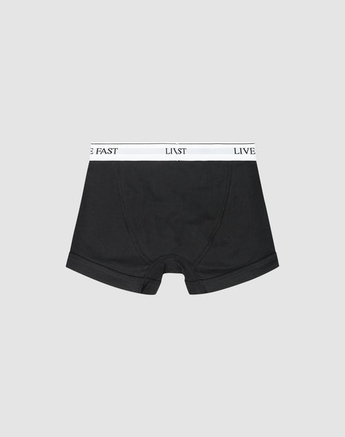 LIVE FAST DIE YOUNG Live Fast Trunks (2 Pack): Black regular-fit boxer briefs with a white waistband featuring LIVE FAST in black text, shown on a light gray background.