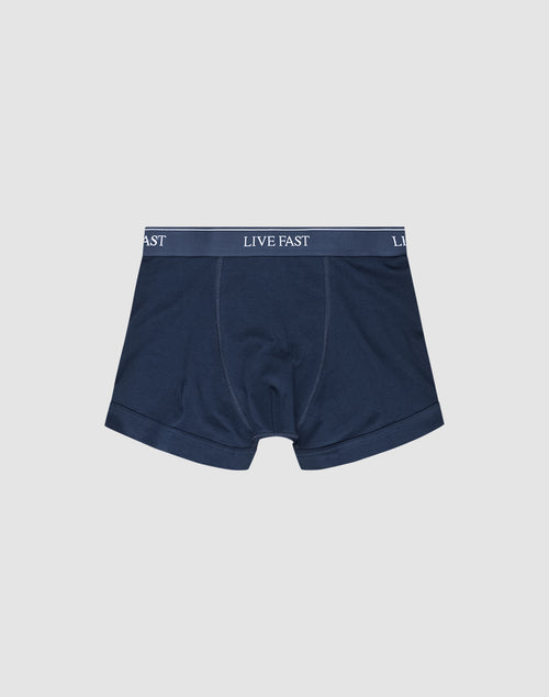 LIVE FAST DIE YOUNGs Live Fast Trunks (2 Pack) feature navy blue mens boxer briefs in a Regular Fit, made from soft cotton with a thick waistband displaying LIVE FAST in white. Shown laid flat on a plain white background.