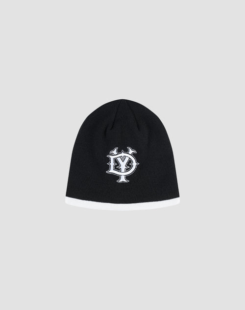 The DY Stripe Beanie by LIVE FAST DIE YOUNG is a black polyester knit with a white bottom trim and an embroidered DY Stick logo on the front, featuring overlapping Y and S letters. Shown on a light gray background. Style code: LF2411-16612.