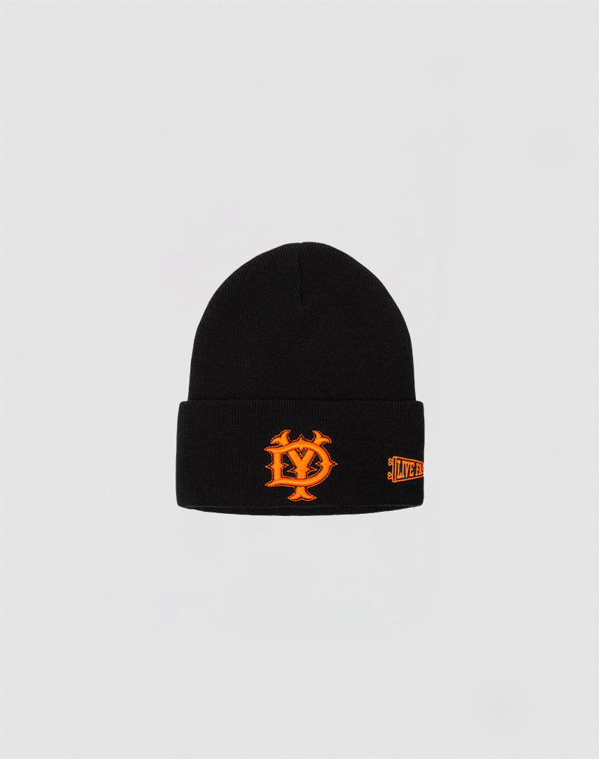 The DY Beanie by LIVE FAST DIE YOUNG is a black polyacryl hat with a bold orange Logo-Stick embroidered on the front and an orange text patch on the side, shown against a plain light gray background.