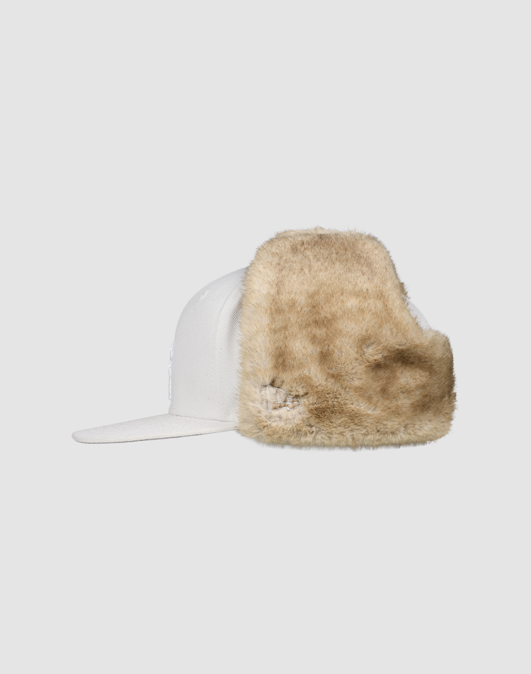 A white LFDY x New Era 59Fifty DogEar cap by LIVE FAST DIE YOUNG, featuring a large light brown faux fur earflap on one side, displayed against a plain light gray background.