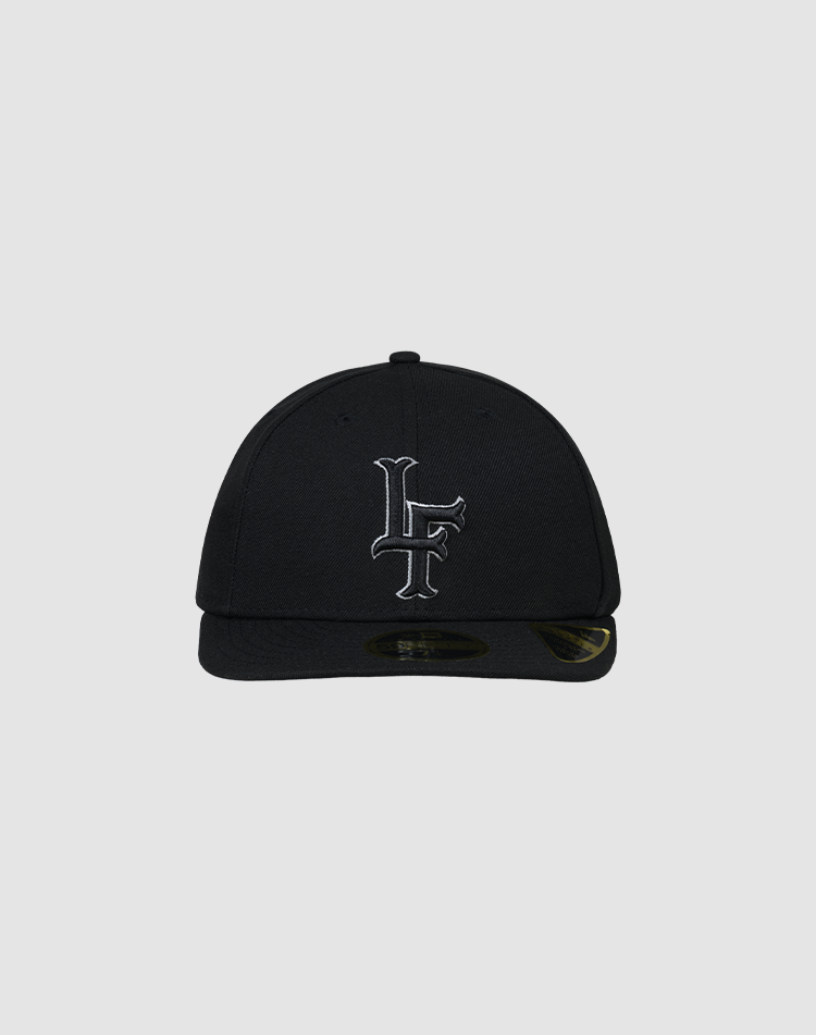 A black LFDY X NEW ERA 59FIFTY Low Profile fitted cap by LIVE FAST DIE YOUNG, featuring a flat brim and white LF initials embroidered on the front, displayed against a plain gray background.