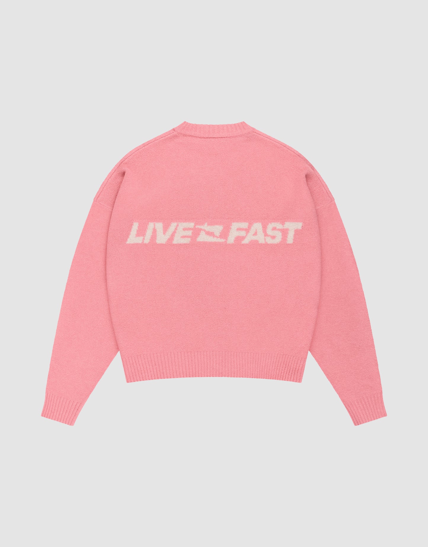 The Live Fast Boucle Sweater by LIVE FAST DIE YOUNG is an oversize pink knit featuring "LIVE FAST" text and a small white graphic on the back.