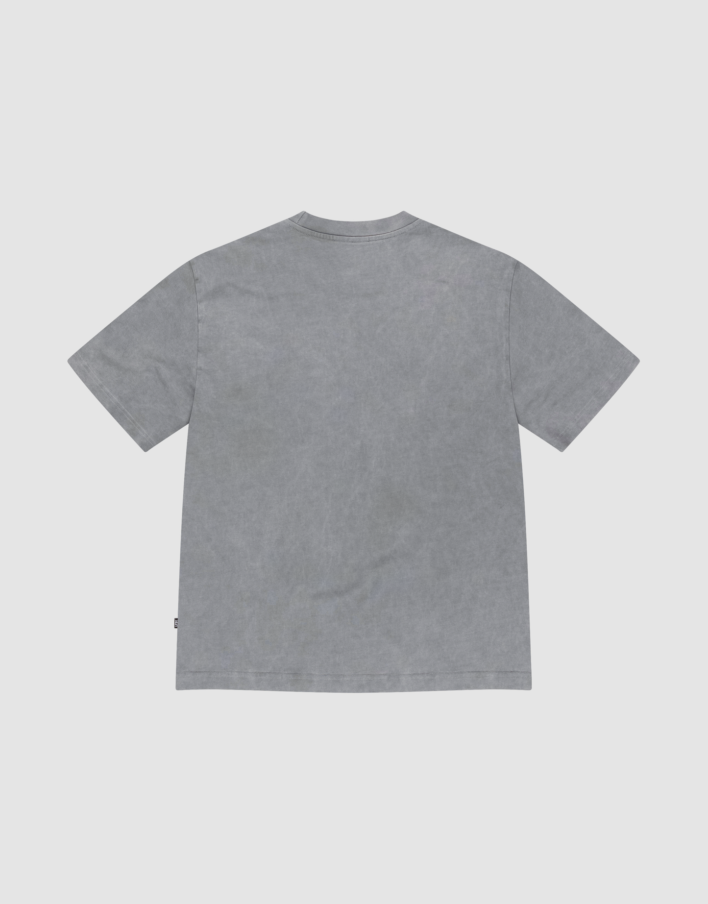 The Basic +49 Tee by LIVE FAST DIE YOUNG, a plain gray oversized short-sleeve t-shirt, is shown laid flat with the back side facing up on a light gray background.