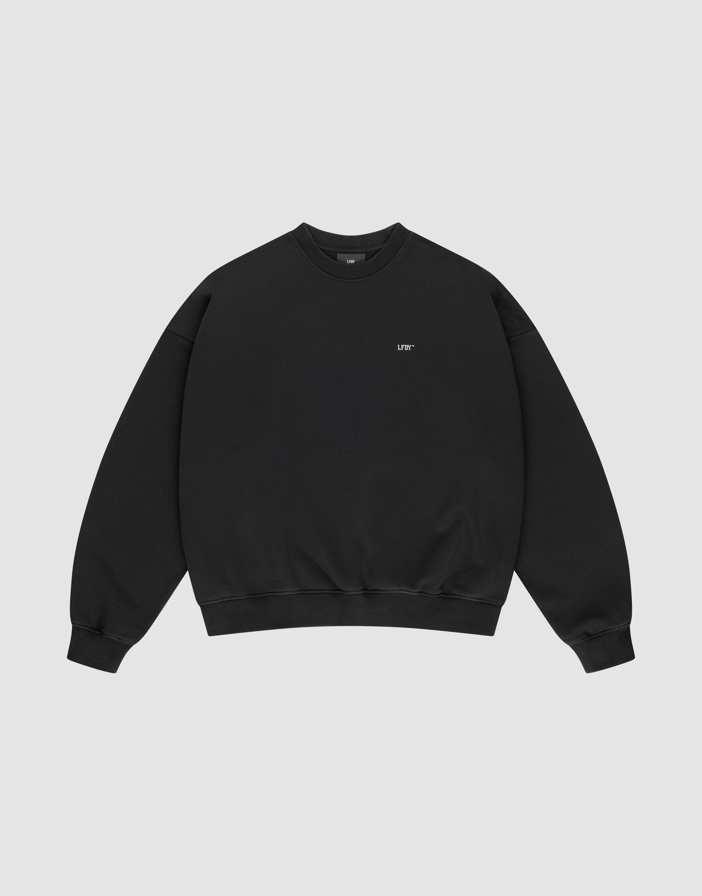 The Basic Evidence Sweater by LIVE FAST DIE YOUNG is a black crewneck with long sleeves, ribbed cuffs, and soft Baumwolle-Polyester blend. Features small white "LIFE" text on the left chest, shown on a light gray background.