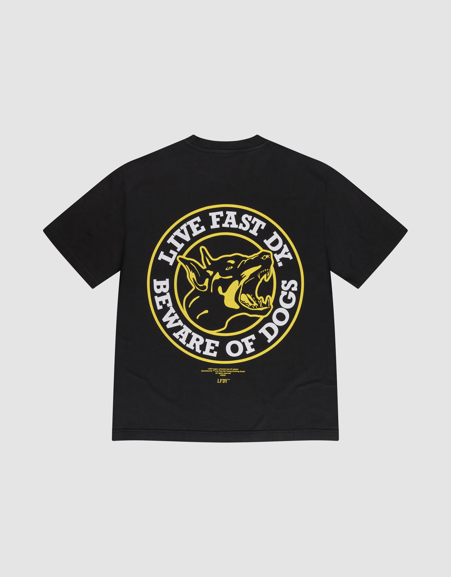 The LFDY Circle Dog Tee by LIVE FAST DIE YOUNG is a black oversized 100% cotton tee with a bold yellow and white snarling dog graphic on the back, encircled by "LIVE FAST DY BEWARE OF DOGS" in capital letters.