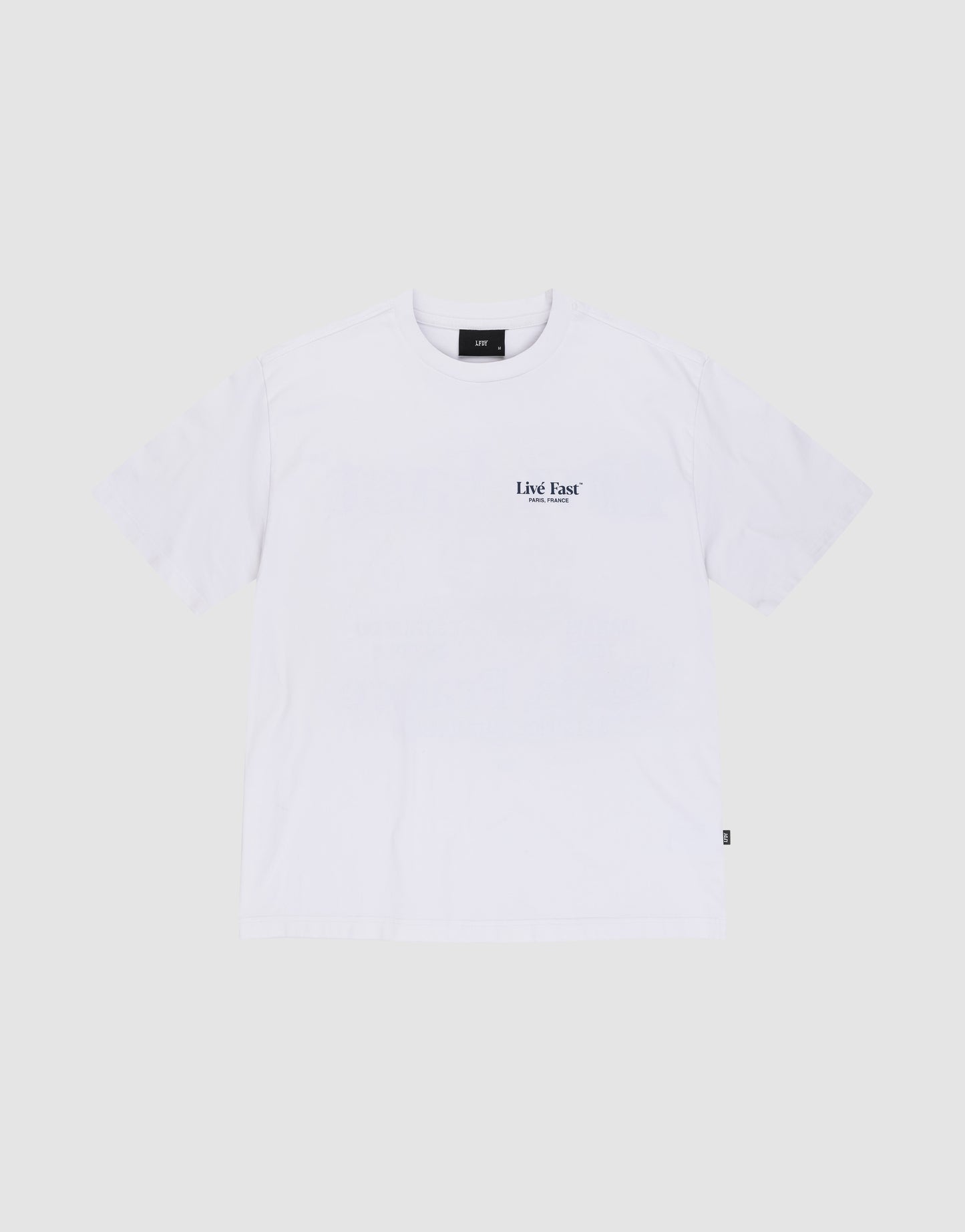 The LFDY Paris Tee by LIVE FAST DIE YOUNG is an oversized white short-sleeve t-shirt made from 100% Baumwolle, featuring a small black "Live Fast" text on the left chest, shown against a light gray background.