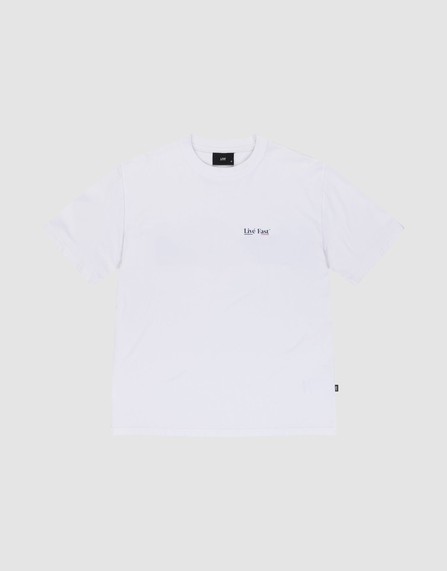 The Live Fast Paris Tee by LIVE FAST DIE YOUNG is a regular fit, short-sleeve white t-shirt made from 100% Baumwolle, featuring small black "Live Fast" text on the left chest, shown on a light gray background.