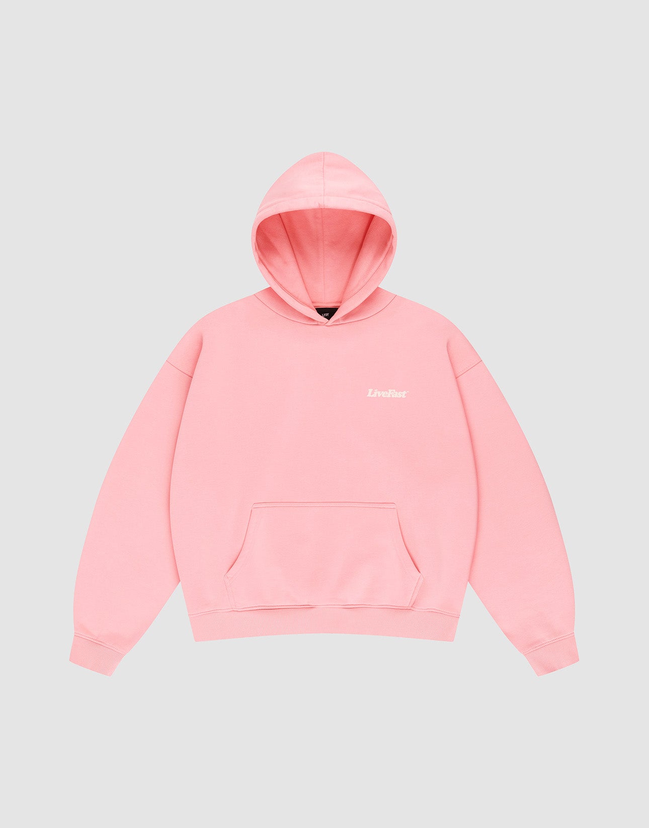 The Basic 360 Hooded by LIVE FAST DIE YOUNG is a light pink oversized sweatshirt with a front pocket and “Livelust” in small white letters on the left chest, neat topstitching, shown on a plain gray background.