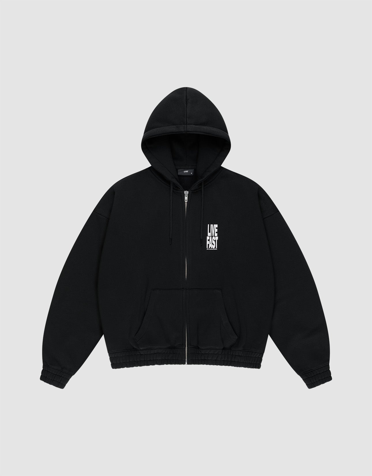 The LIVE FAST DIE YOUNG Live Fast Lenox Hooded Zip is a black oversized cotton hoodie with a zip-up front, hood, and front pockets, featuring a white LIVE FAST logo on the left chest, shown on a light gray background.