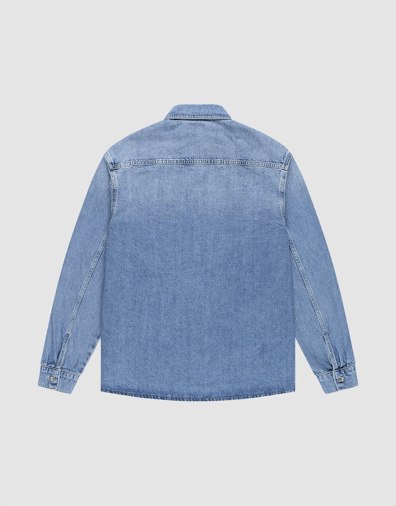 The LFDY® Denim Shirt by LIVE FAST DIE YOUNG is a light blue, long-sleeve, oversize-fit shirt with a classic two-piece collar and buttoned cuffs. Made from 100% cotton, it’s shown from the back on a plain white background. No visible pockets or designs.